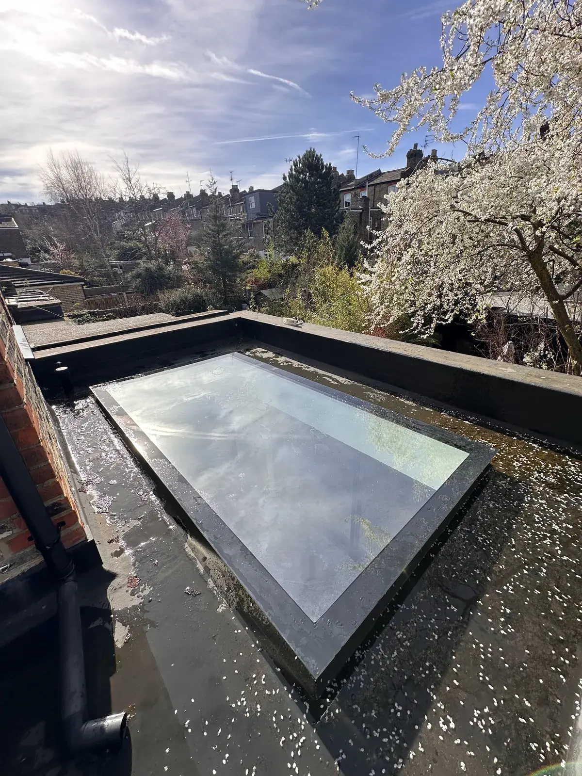 Glass roof lantern cleaned on a flat roof extension