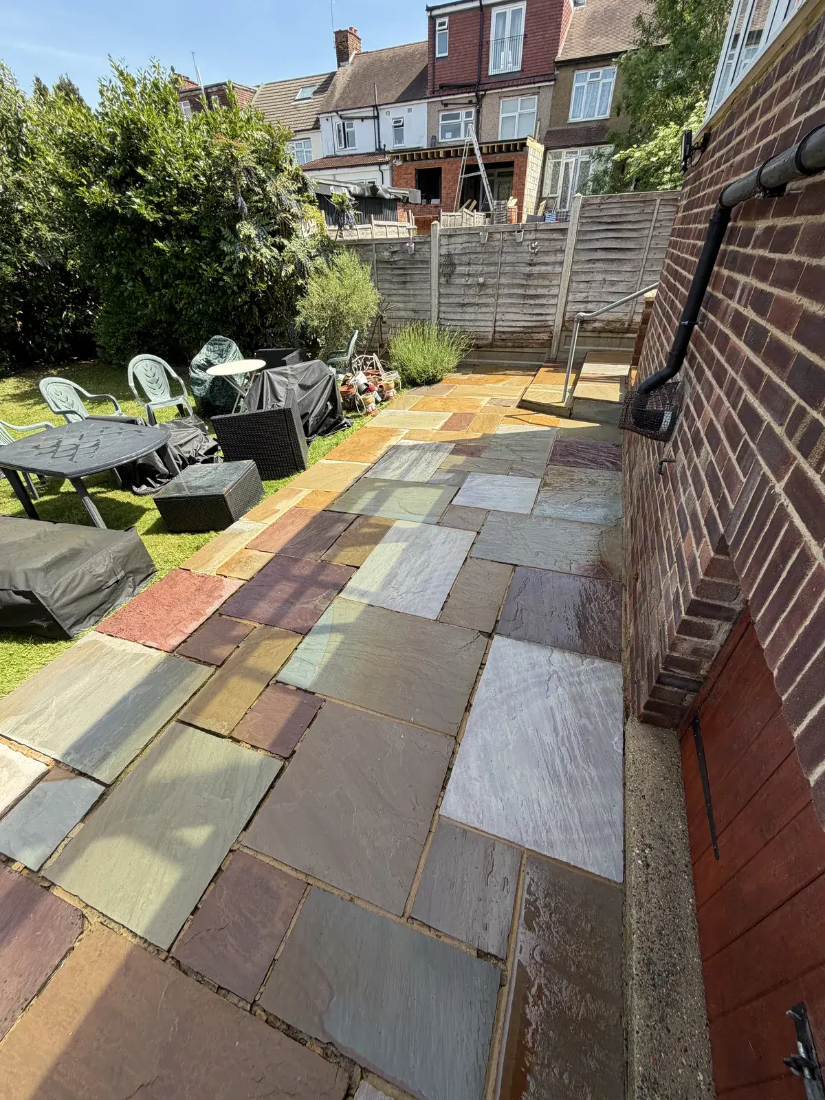 Indian sandstone patio cleaned back to its original colours