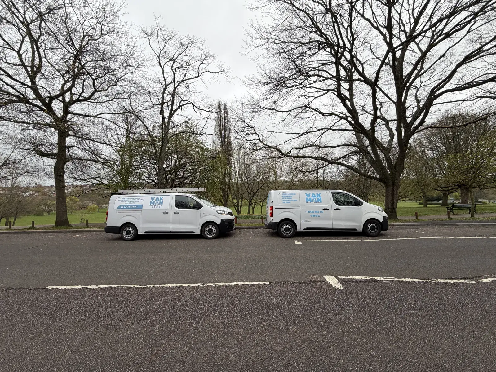 Two Vakman Exterior Cleaning vans parked on a North London street